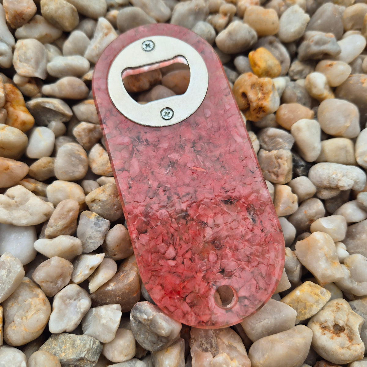 Resin bottle opener with inlaid rose quartz stones