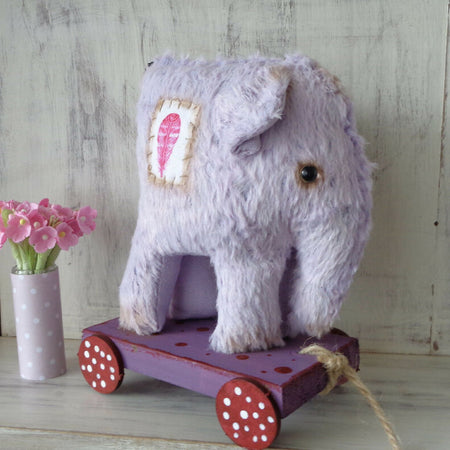 Purple Elephant on wooden cart