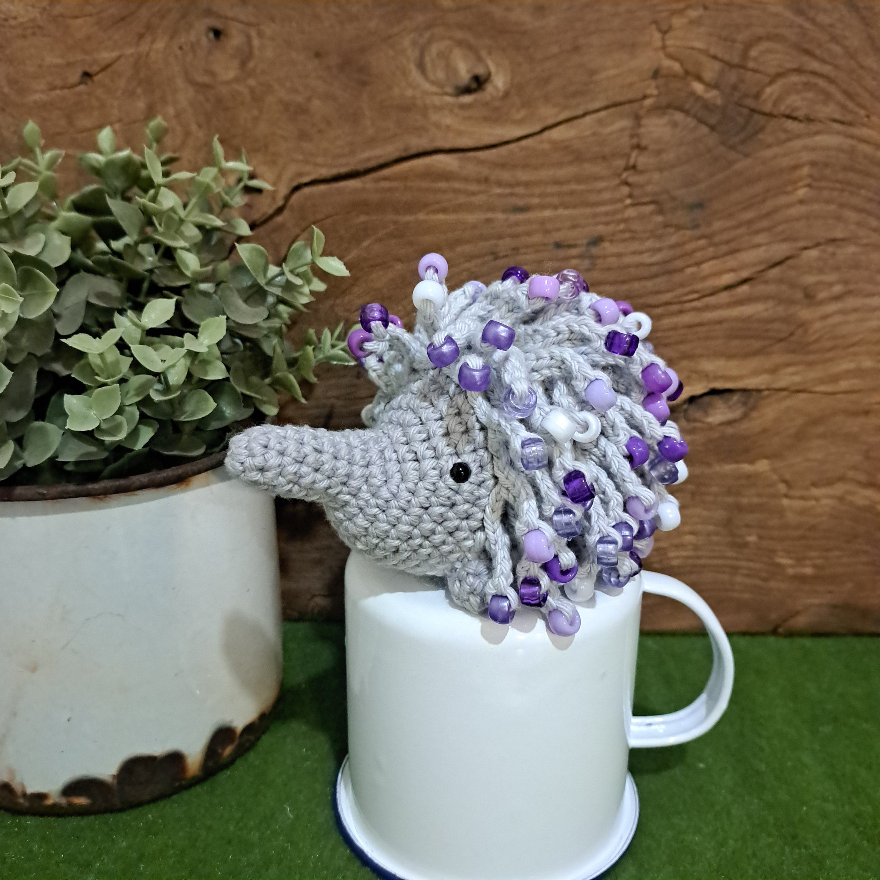 Handmade crochet echidna in grey cotton with mauve beads