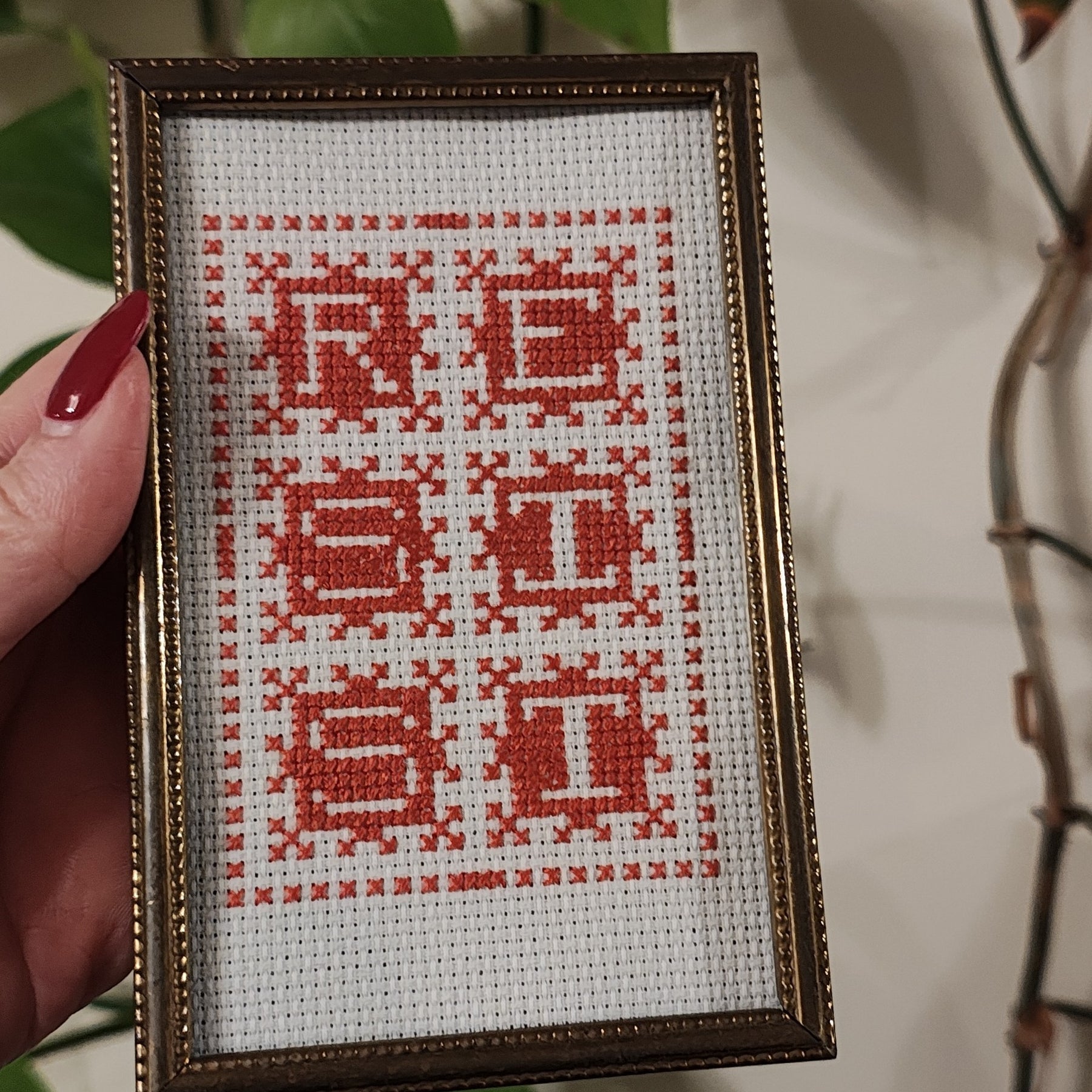 "RESIST" framed cross-stitch