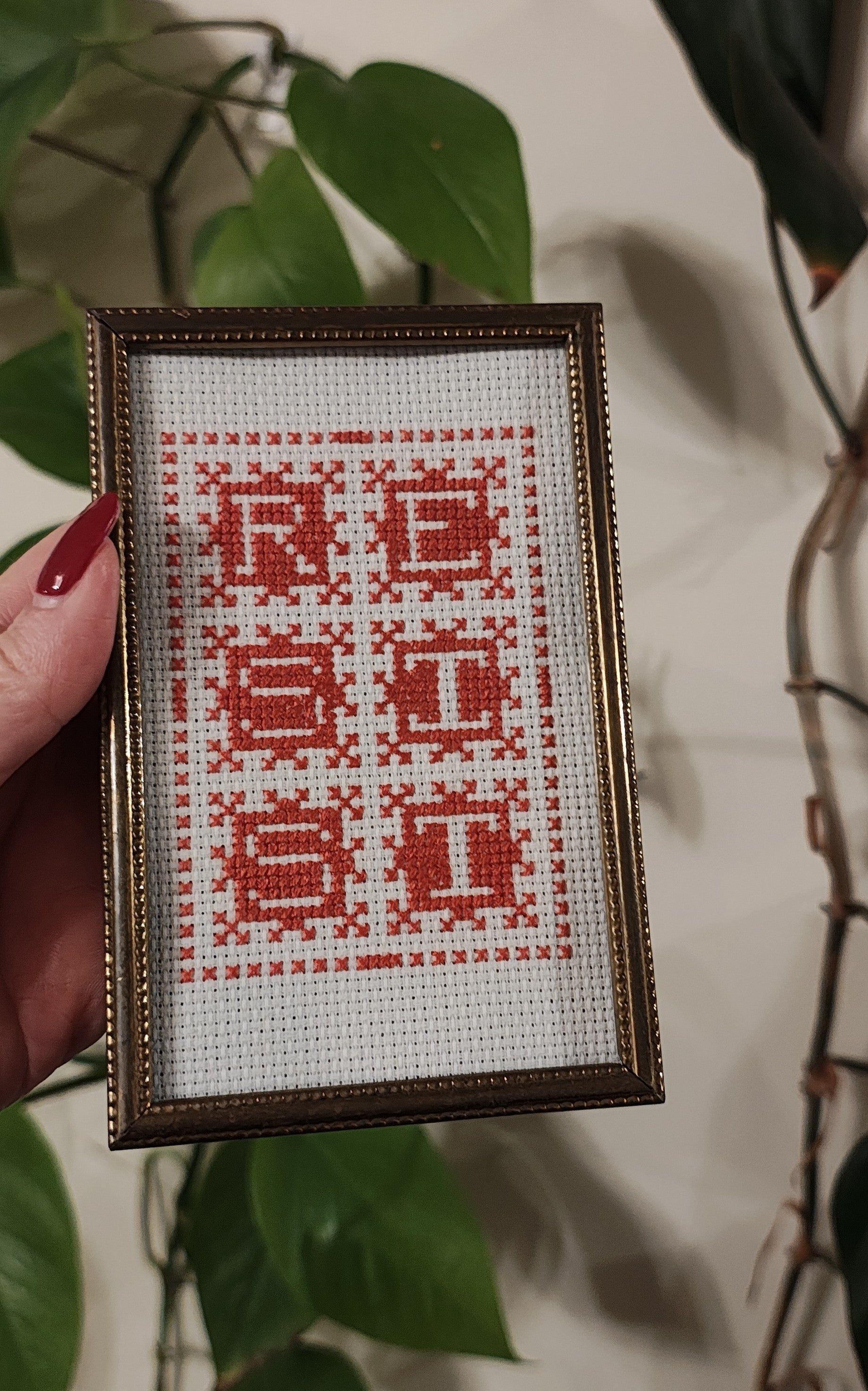 "RESIST" framed cross-stitch