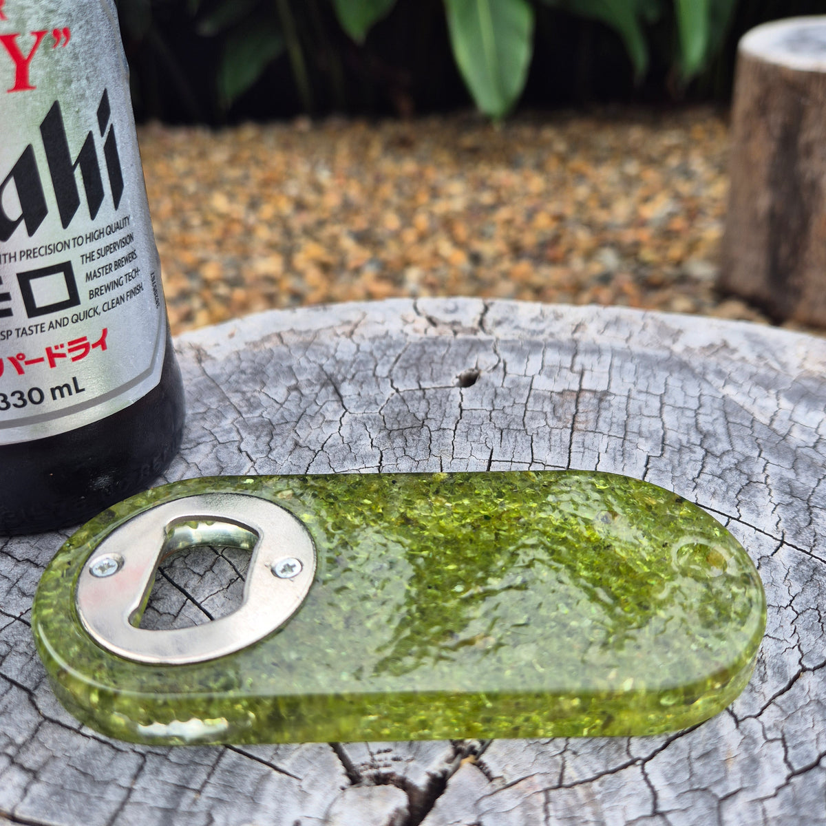 Resin bottle opener with inlaid peridot stones