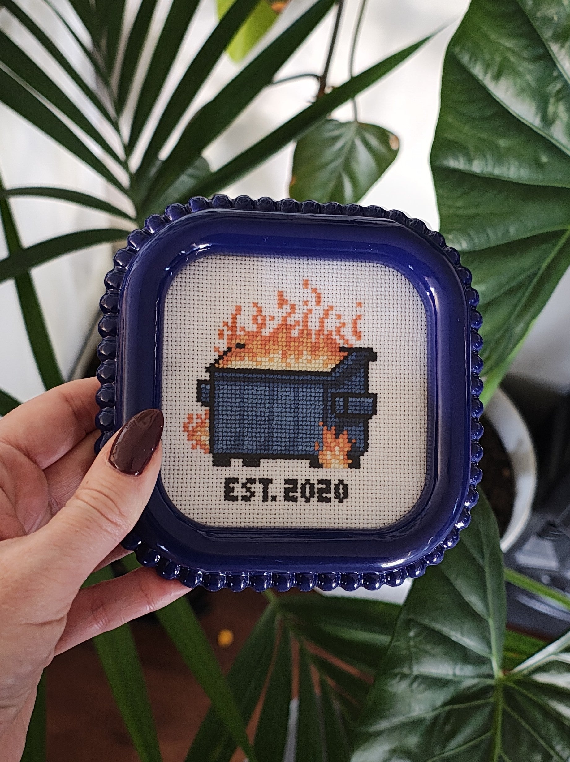 "Dumpster fire" framed cross stitch