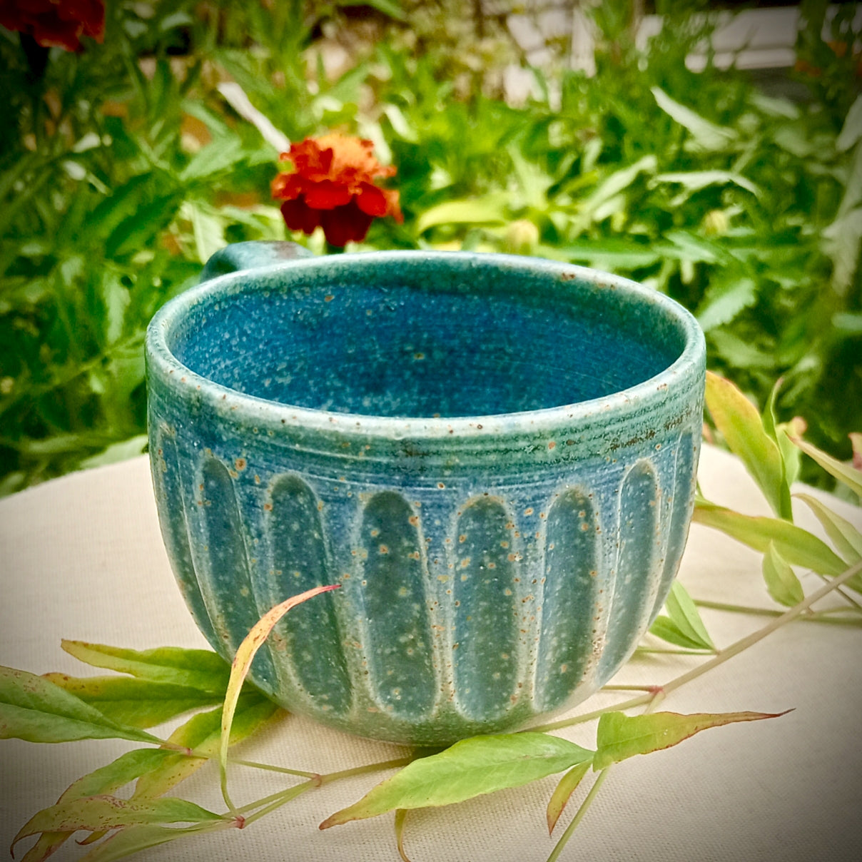 Blue Fluted cup with amber flecks
