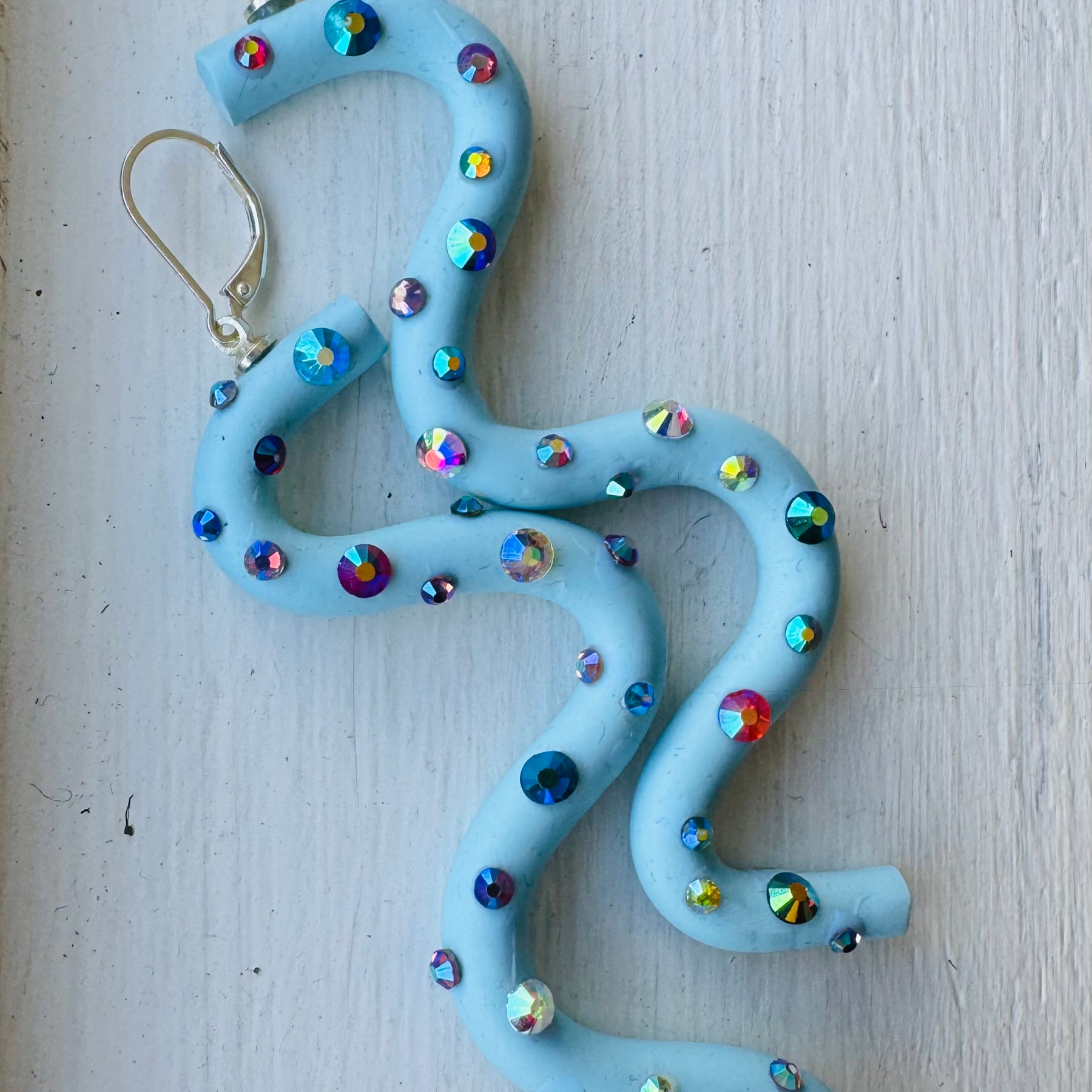 Pastel blue squiggle polymer clay earrings with holographic gems
