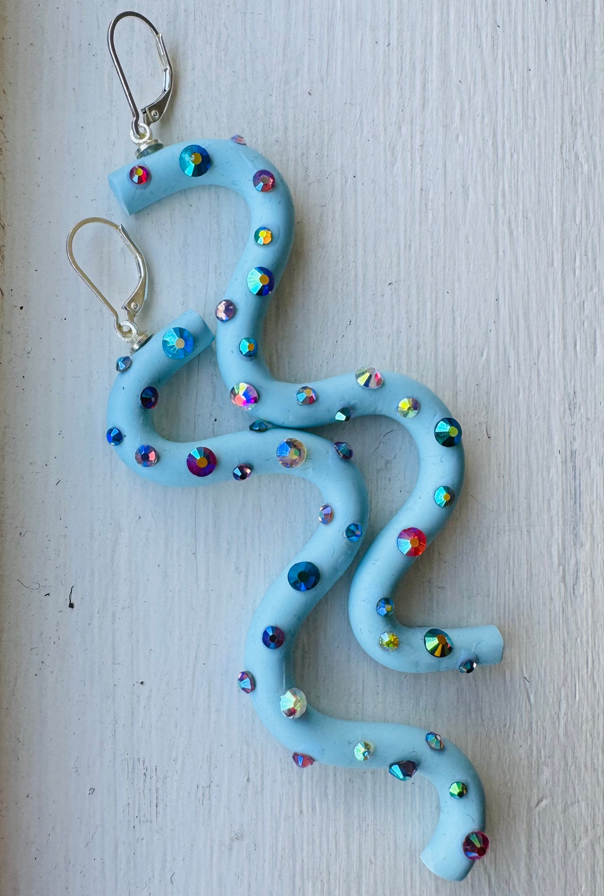 Pastel blue squiggle polymer clay earrings with holographic gems