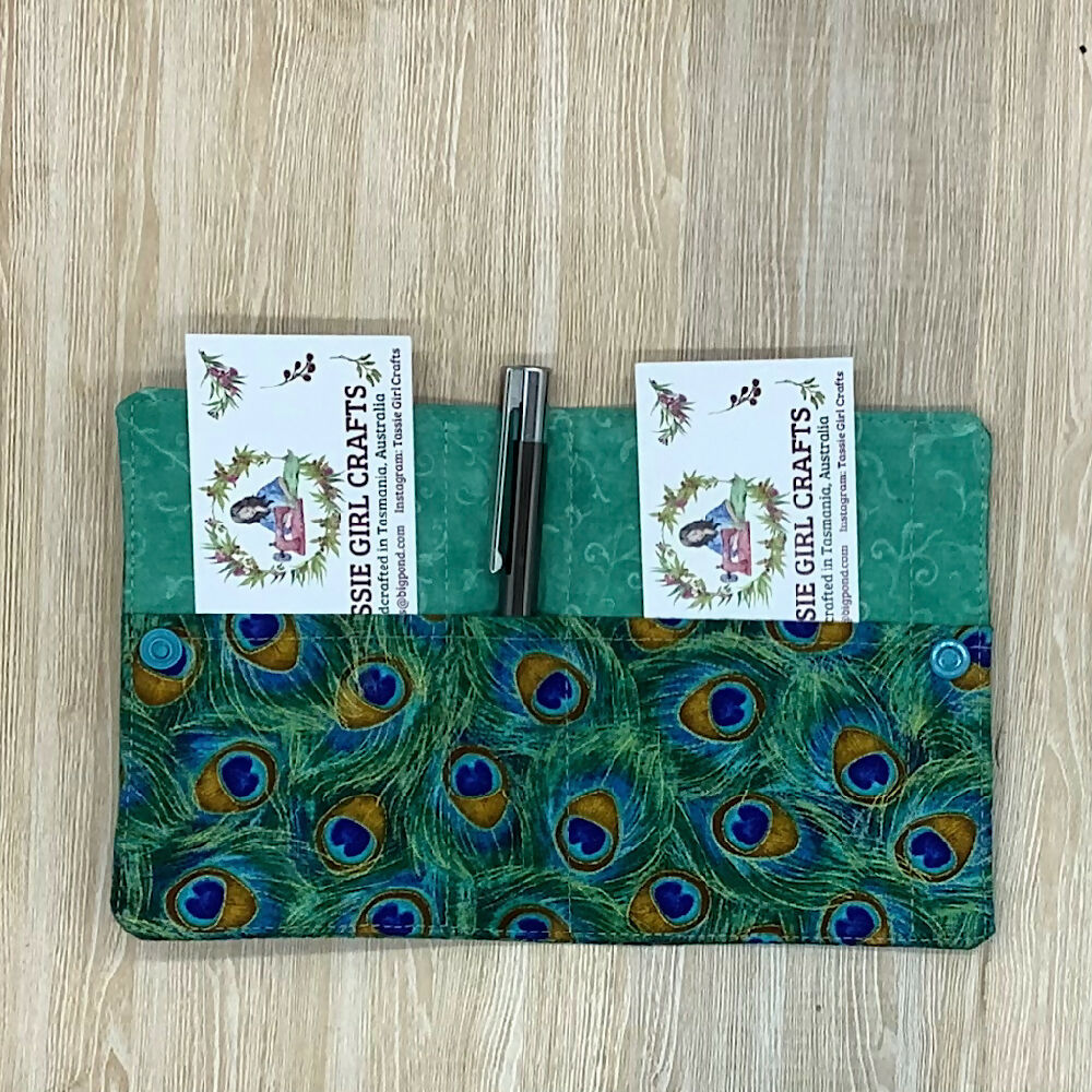 Peacock feathers refillable fabric pocket notepad cover with snap closure. Incl. book and pen.