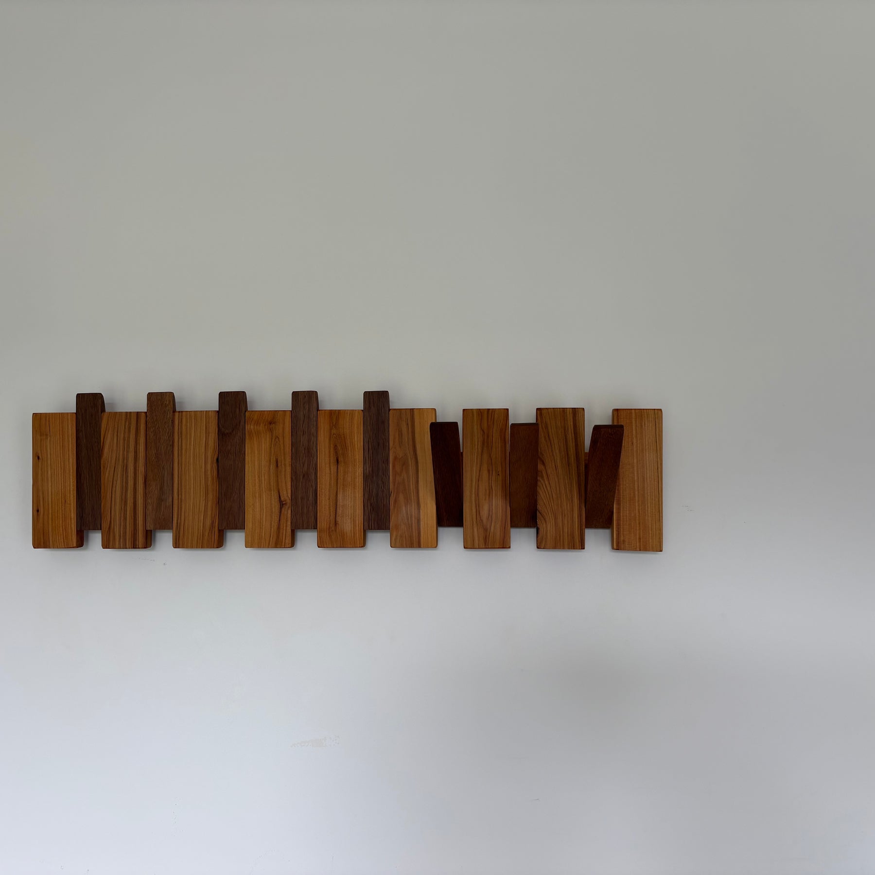 Two tone piano style coatrack