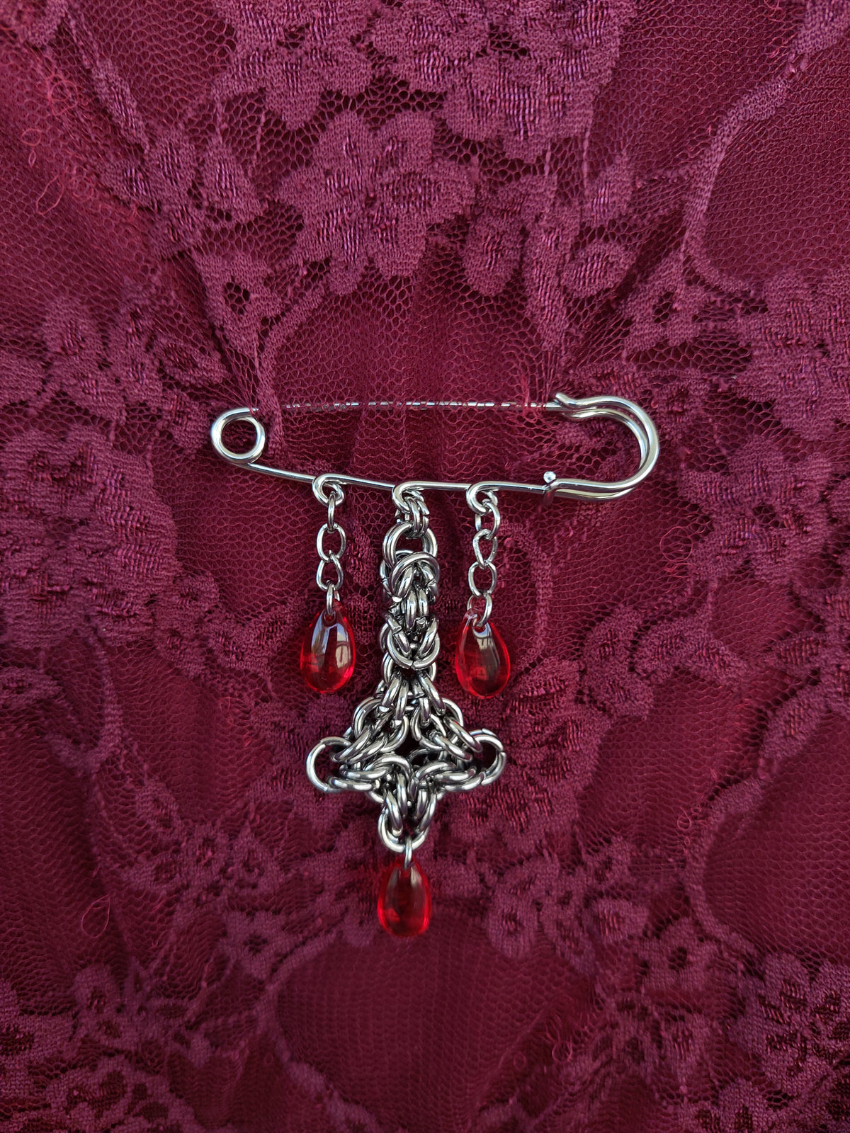 Bleeding cross brooch