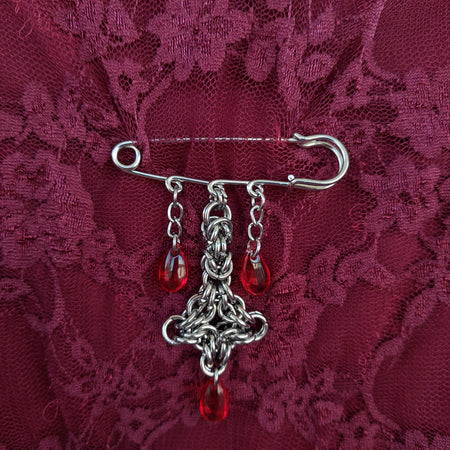 Bleeding cross brooch
