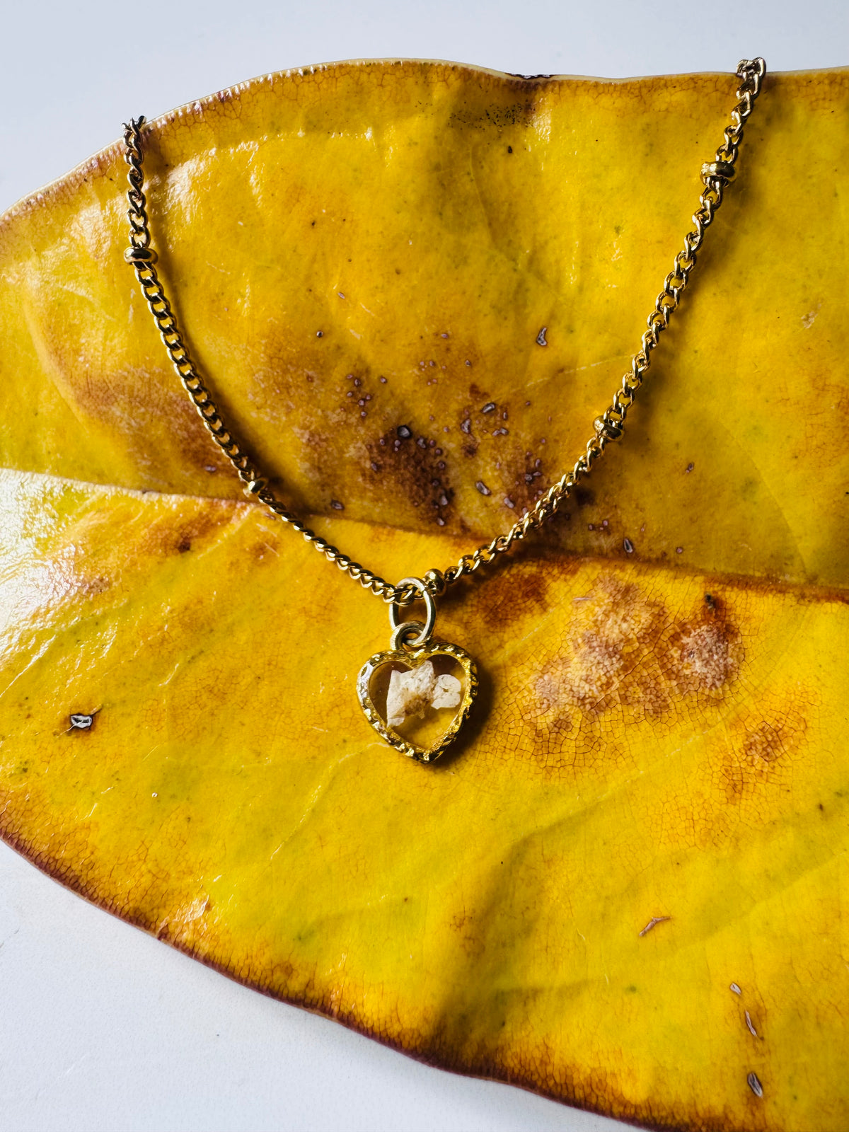 Gold plated resin necklace with white wildflower