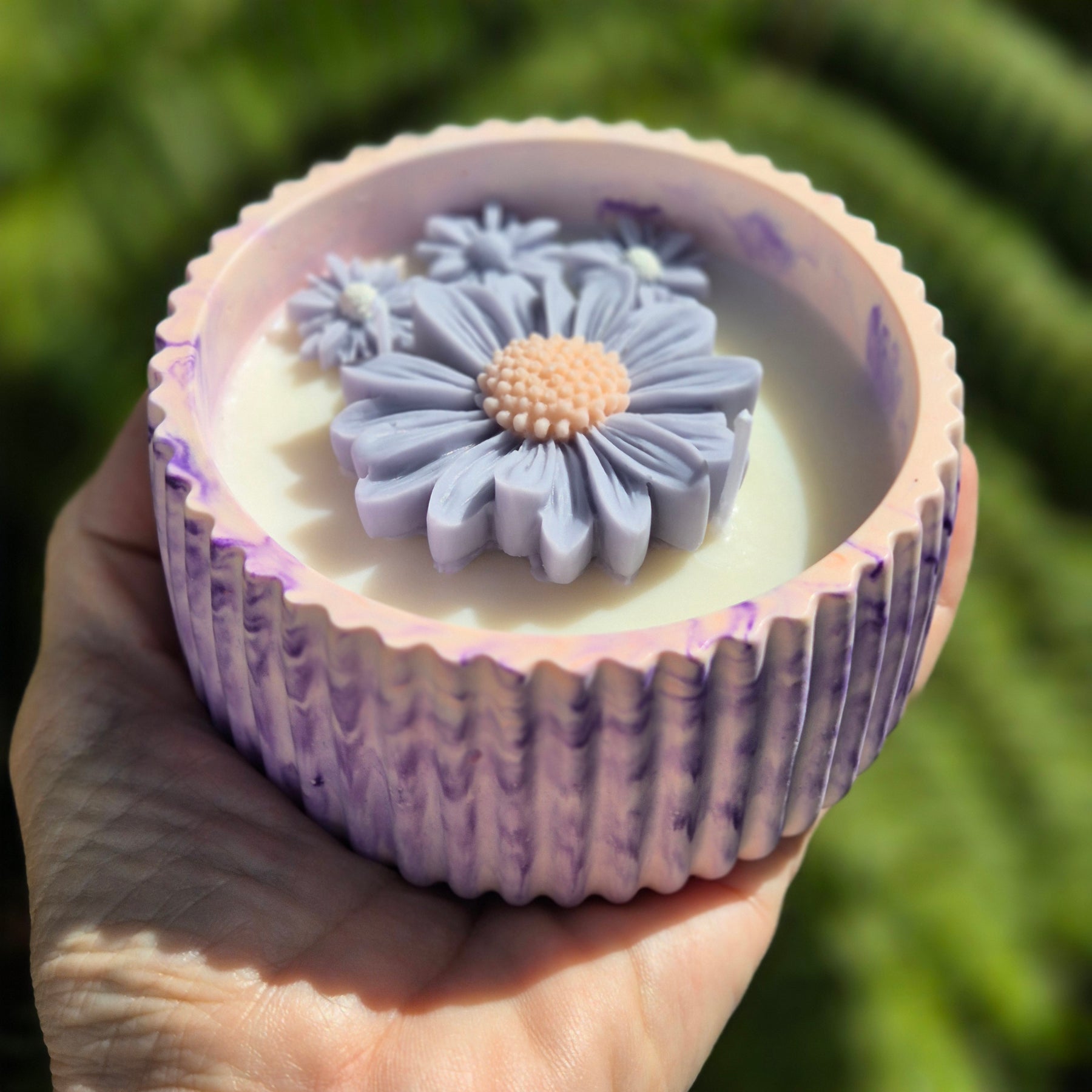 Round orange and purple concrete bowl candle with rose and lavender scent