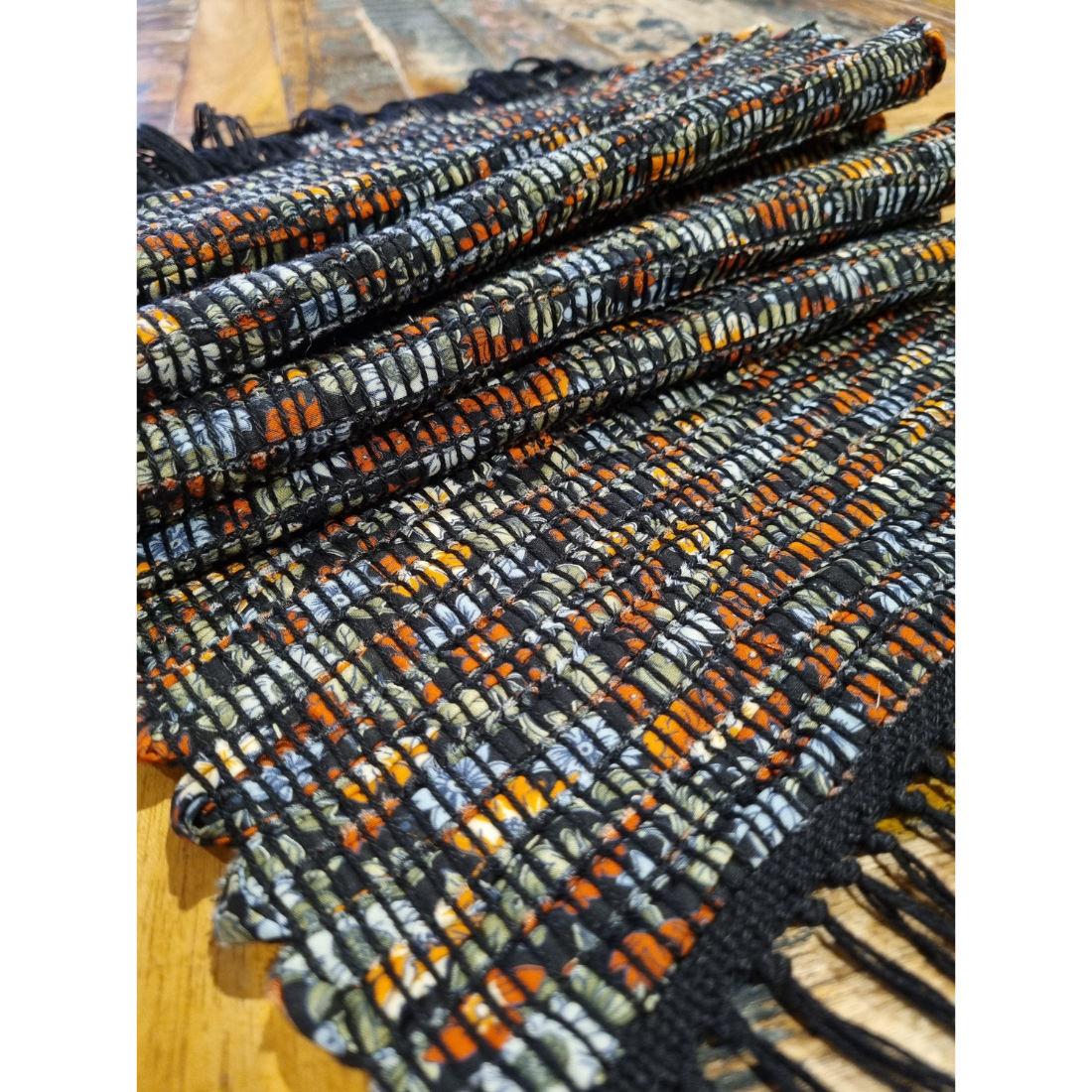 Woven black and orange floral tablerunner