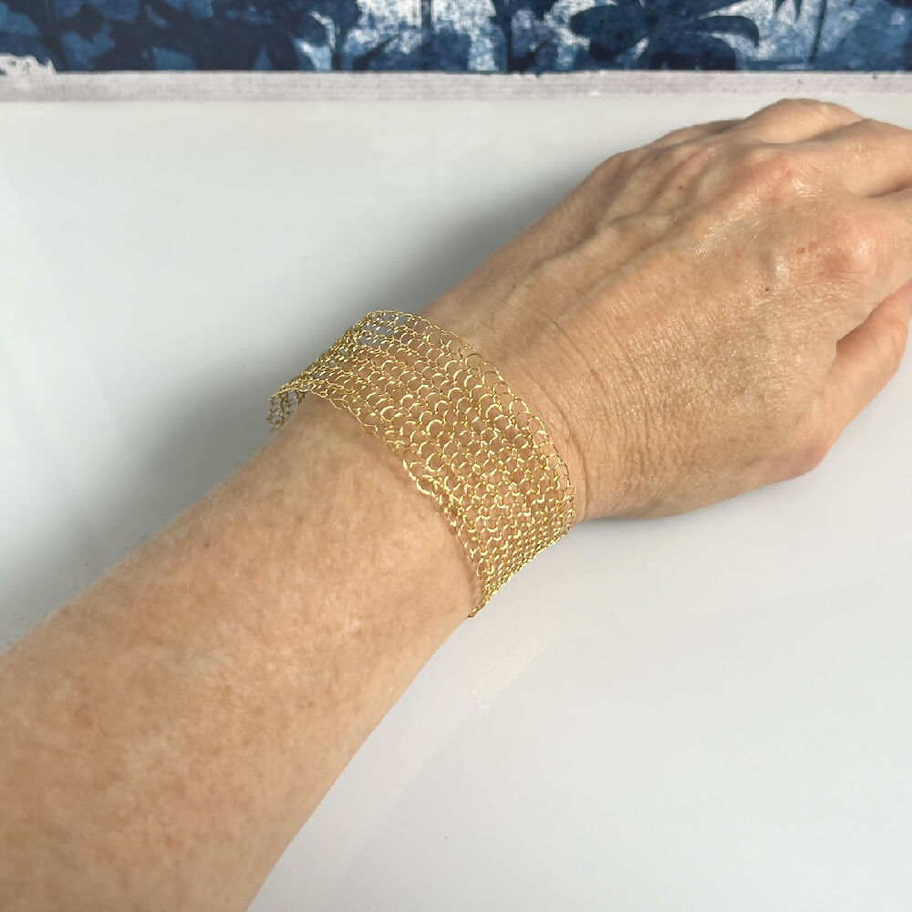 Knitted gold colour bracelet model