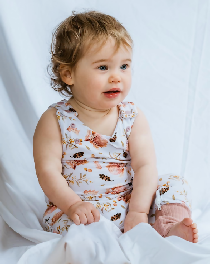 Proteas and wattle grow romper on baby