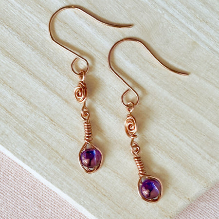 Copper wire dangle earrings with shimmer purple glass beads