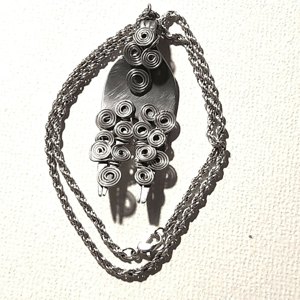 Recycled cutlery pendant with Egyptian coiled wire.