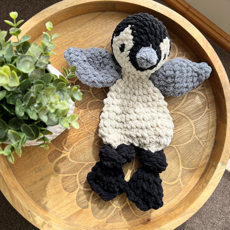 Handmade crochet modern Penguin lovey snuggler with knotted legs.