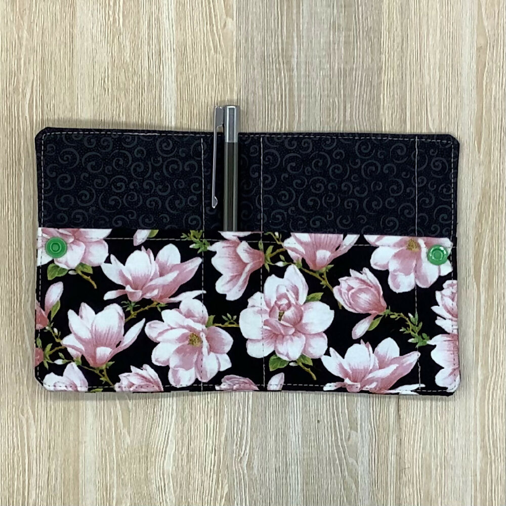 Pink floral refillable fabric pocket notepad cover with snap closure. Incl. book and pen.