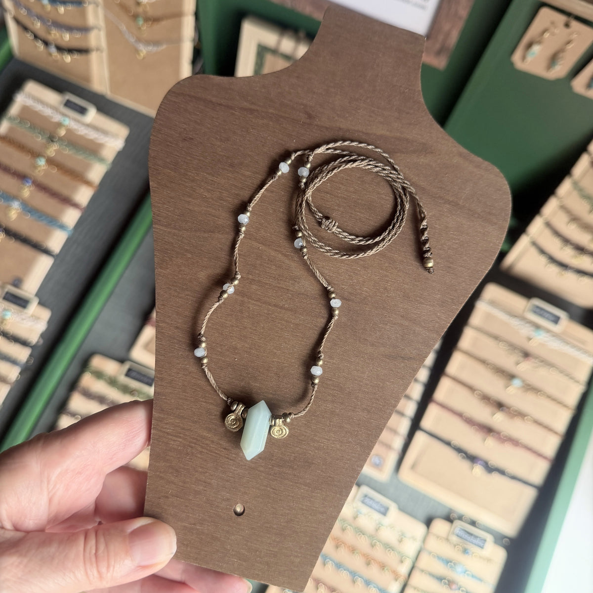 Crystal point necklace with faceted beads and solid brass charm