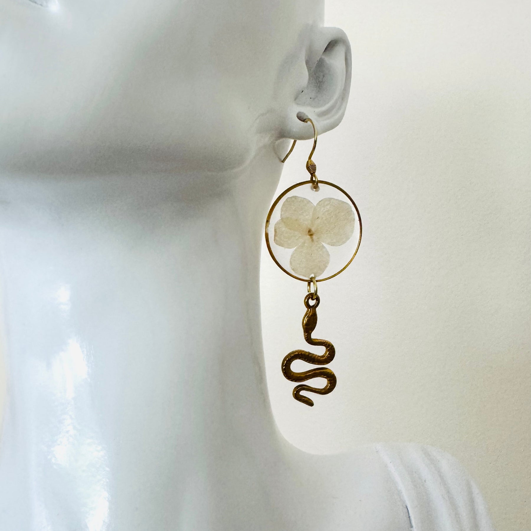 White pressed flower resin earrings with gold snake