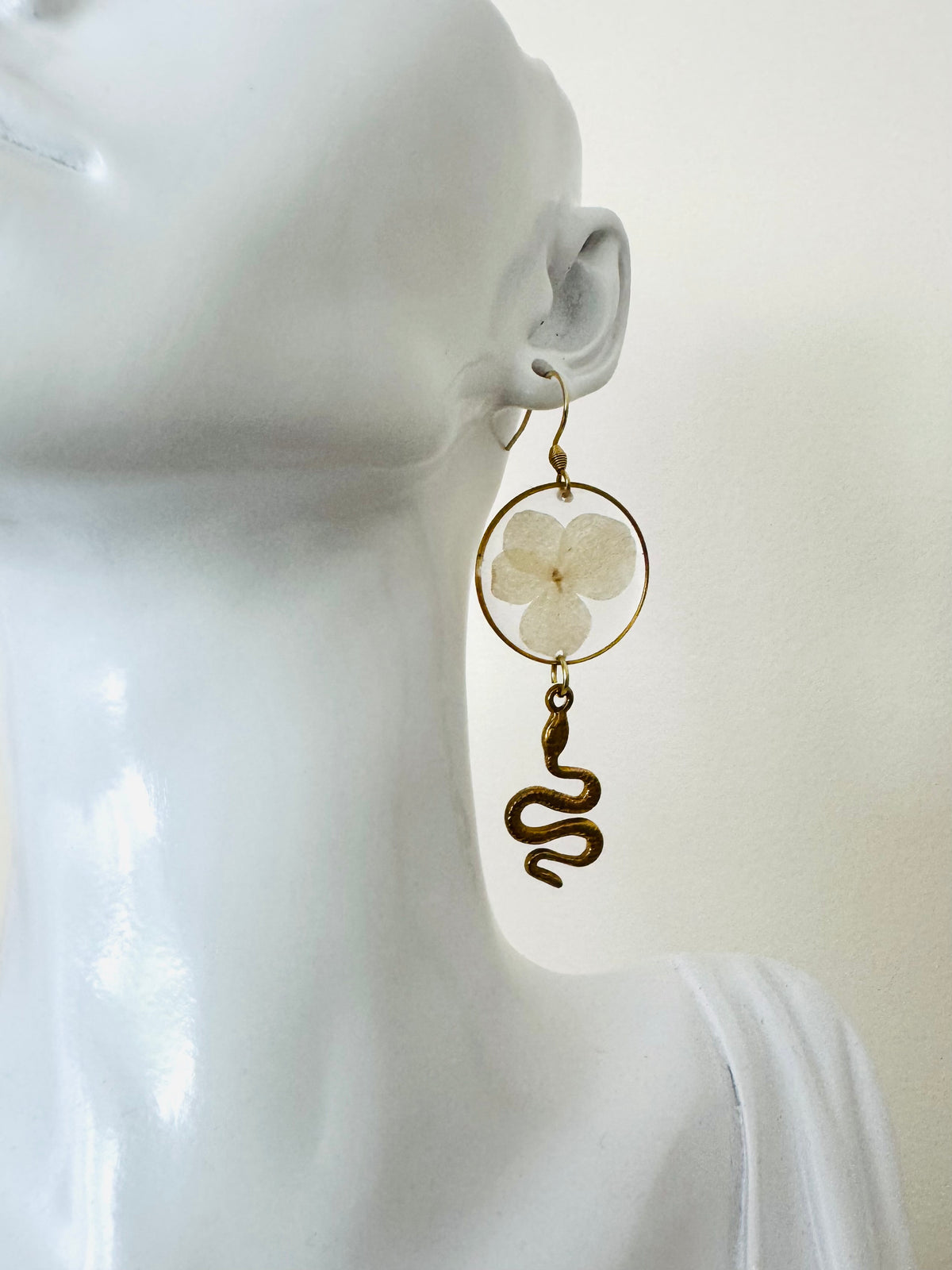 White pressed flower resin earrings with gold snake