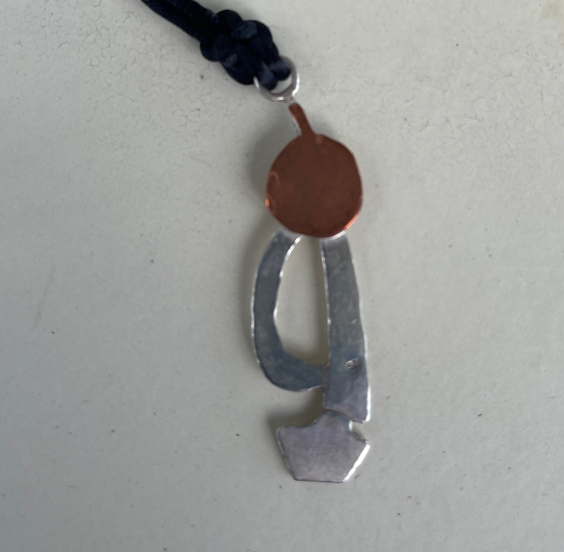 Silver and copper sailing boat into the blood moon