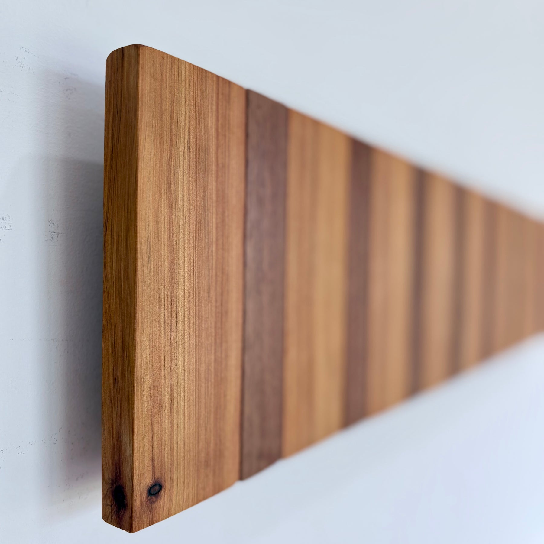 Two tone spotted gum and cypress horizon line piano style coatrack