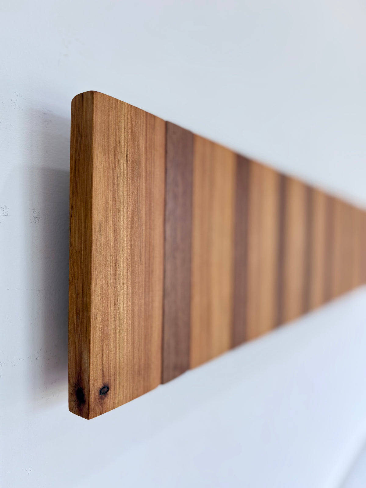 Two tone spotted gum and cypress horizon line piano style coatrack