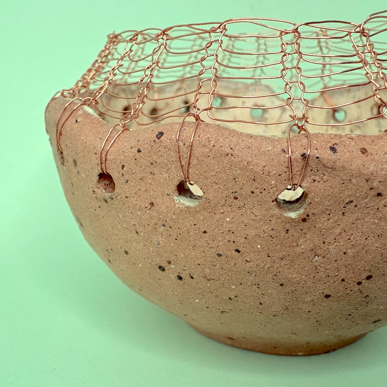 Ceramic bowl with knitted wire