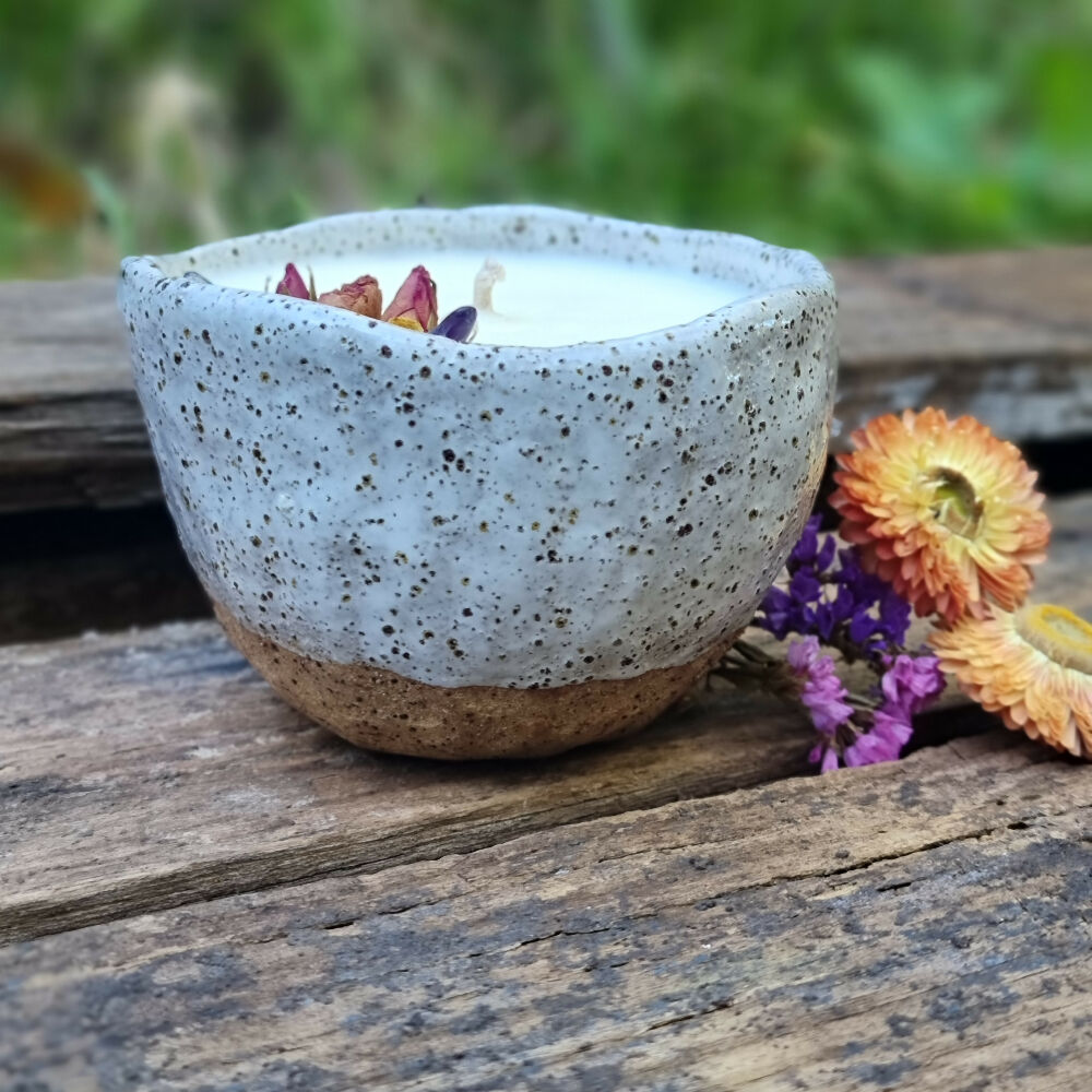 Soy candle in a speckled pottery bowl with matte white glaze