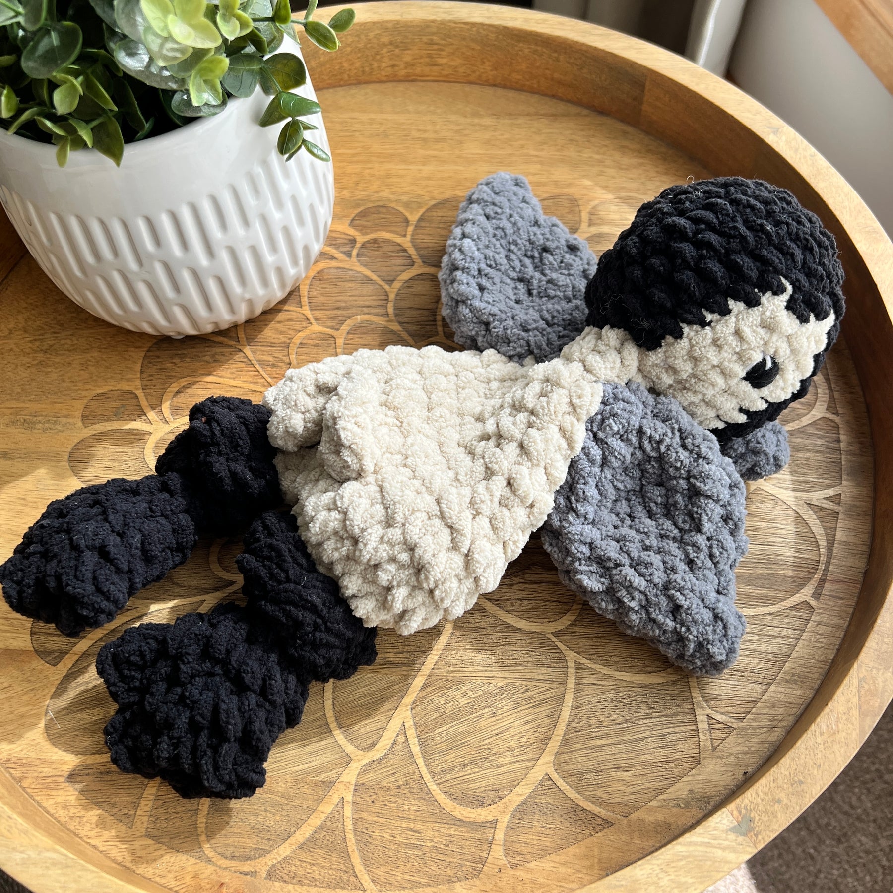 Handmade crochet modern Penguin lovey snuggler with knotted legs.