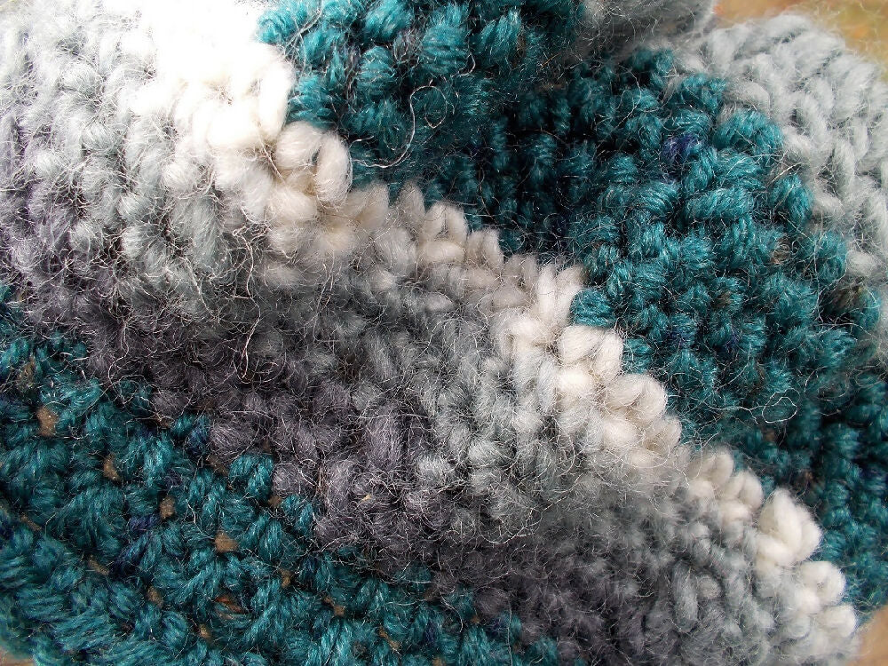 Crocheted winter hat in teal, grey and white wool