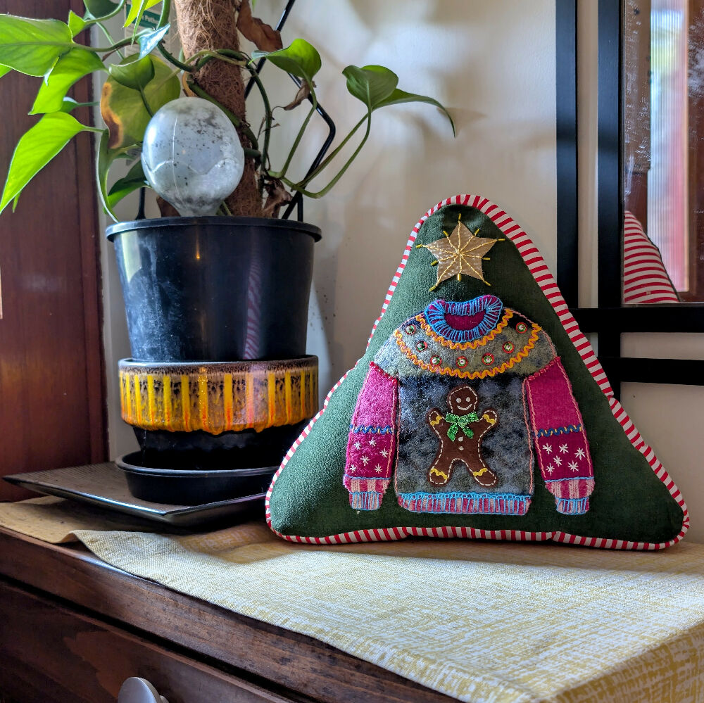 Gingerbread cushion next to plant