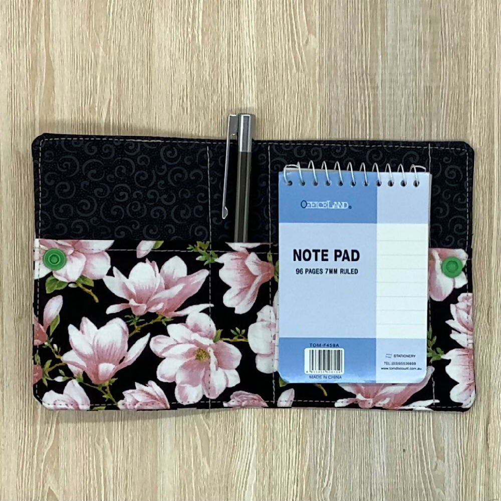Pink floral refillable fabric pocket notepad cover with snap closure. Incl. book and pen.