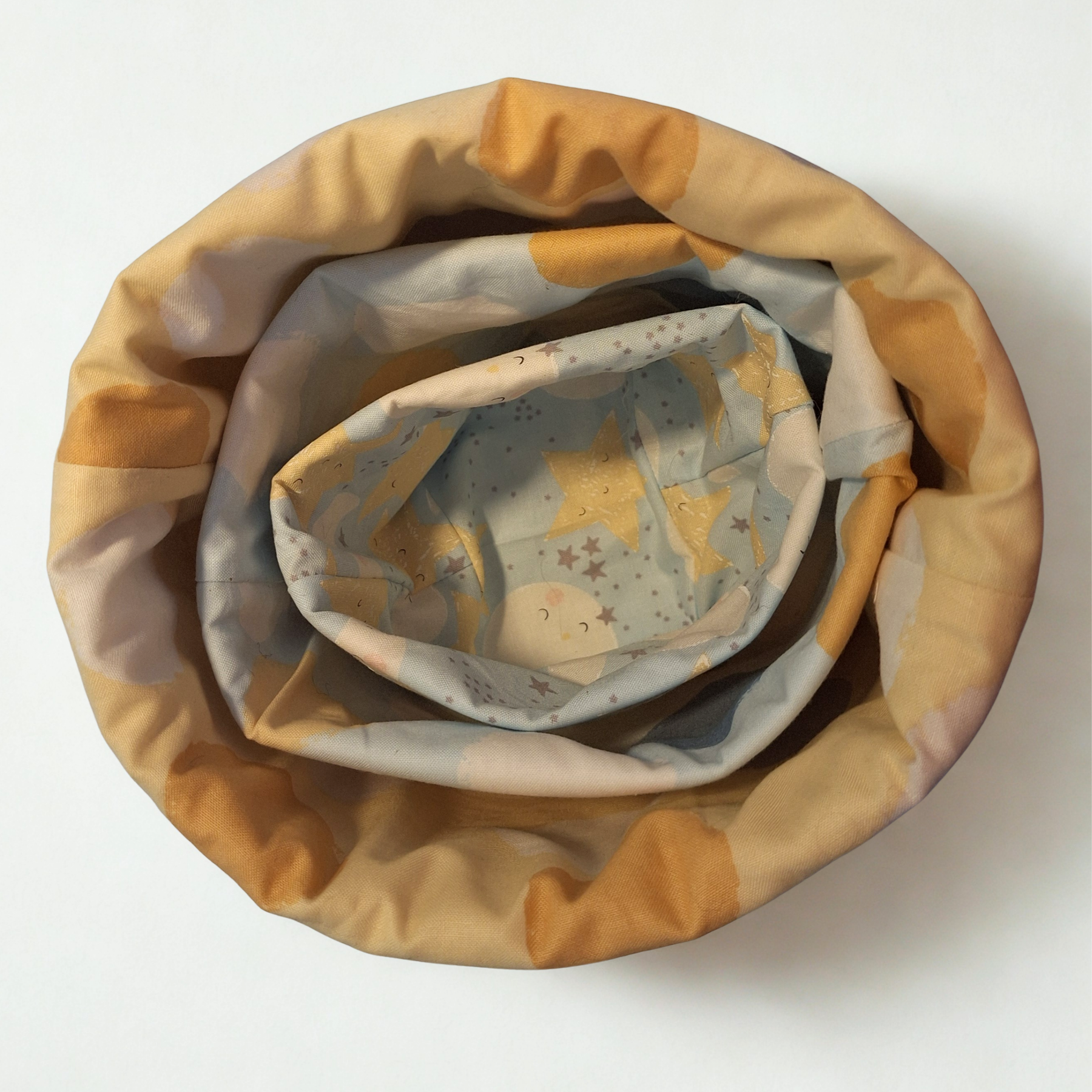 Reversible handmade nesting fabric baskets for baby's room