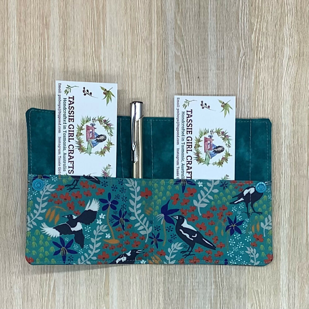 Magpie refillable fabric pocket notepad cover with snap closure. Incl. book and pen.