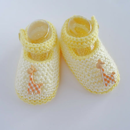 Cream and yellow baby booties with giraffes