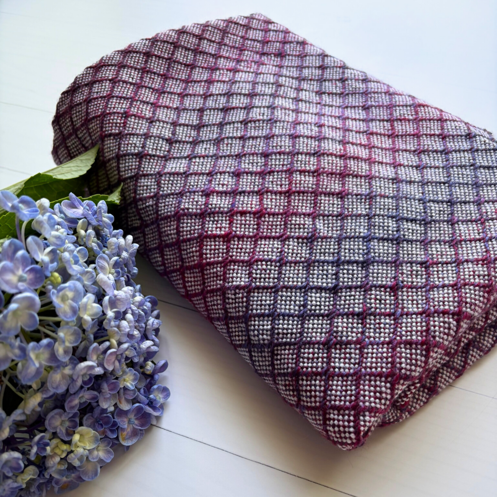 Closeup-folded-with-flower-handwoven-purple-baby-blanket-entangledhappiness-handwoven