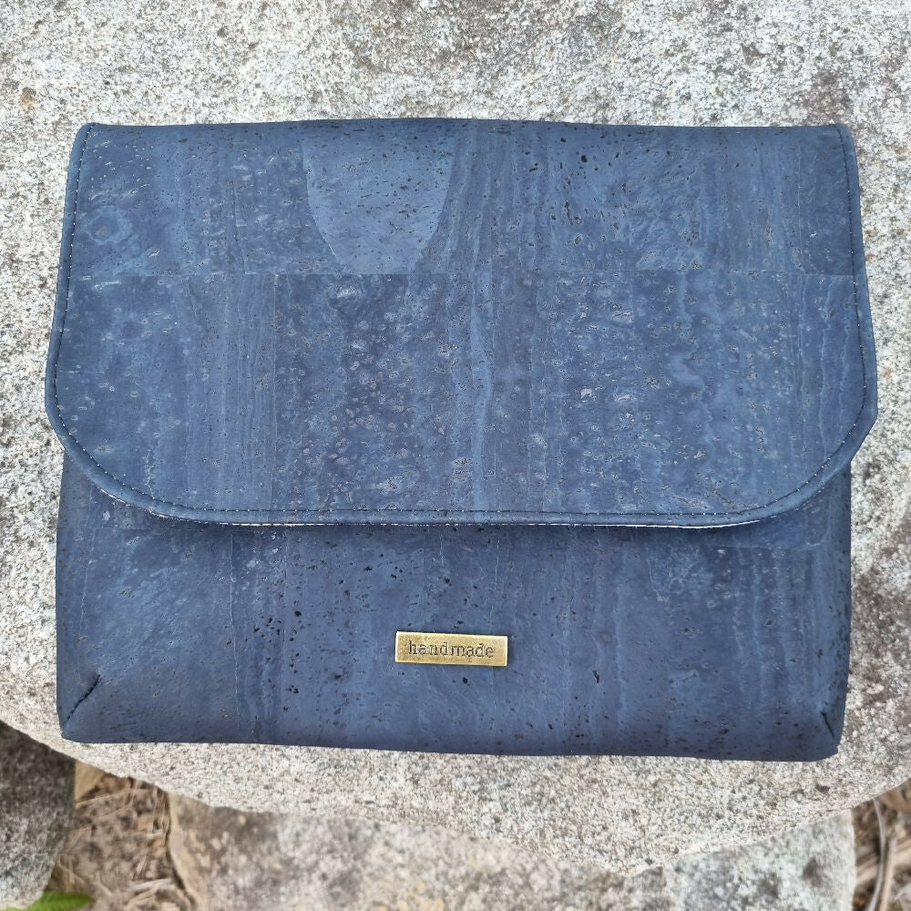 iPad cover or clutch in cork. The front view shows a curved flap.