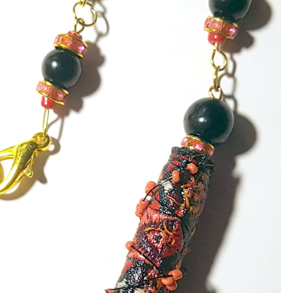 Necklace, beaded. Wire wrapped fabric beads in red and black.