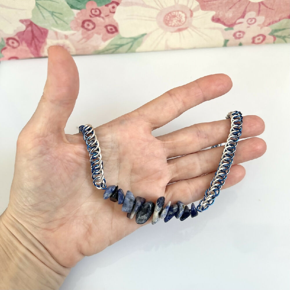 Silver plated half persian sodalite necklace in hand