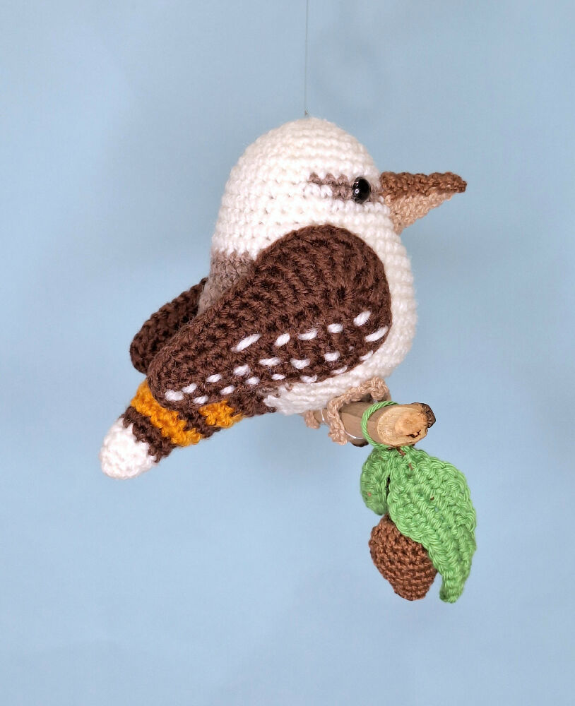 Crocheted laughing Kookaburra room decoration on perch