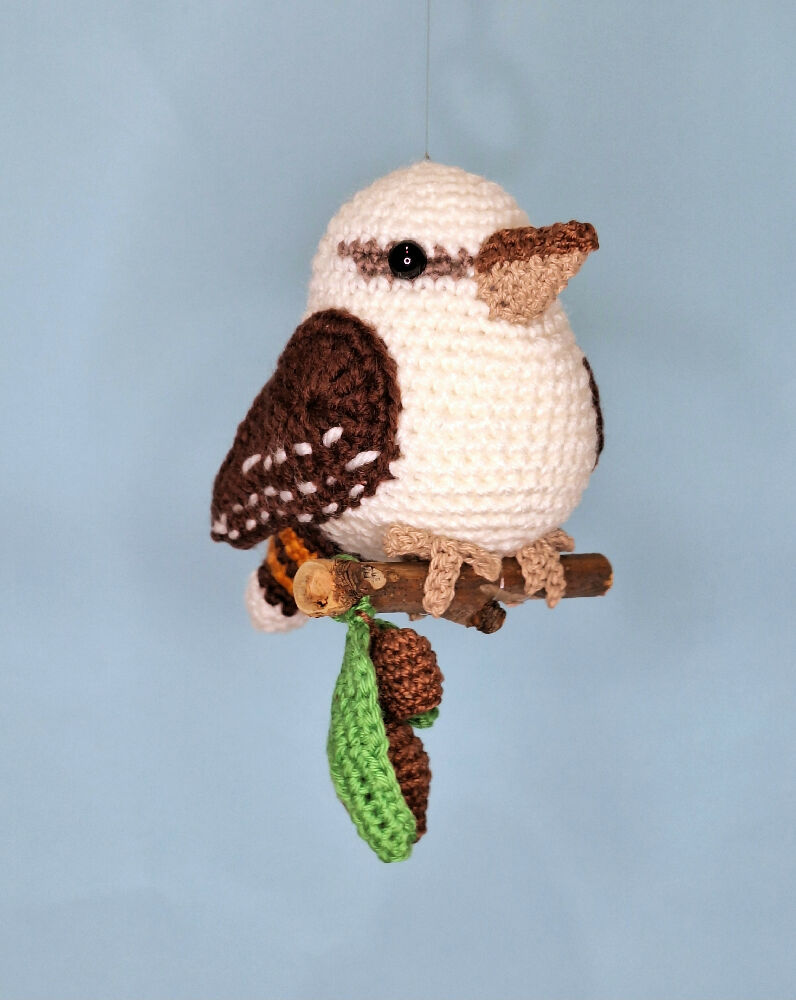 Crocheted laughing Kookaburra room decoration on perch