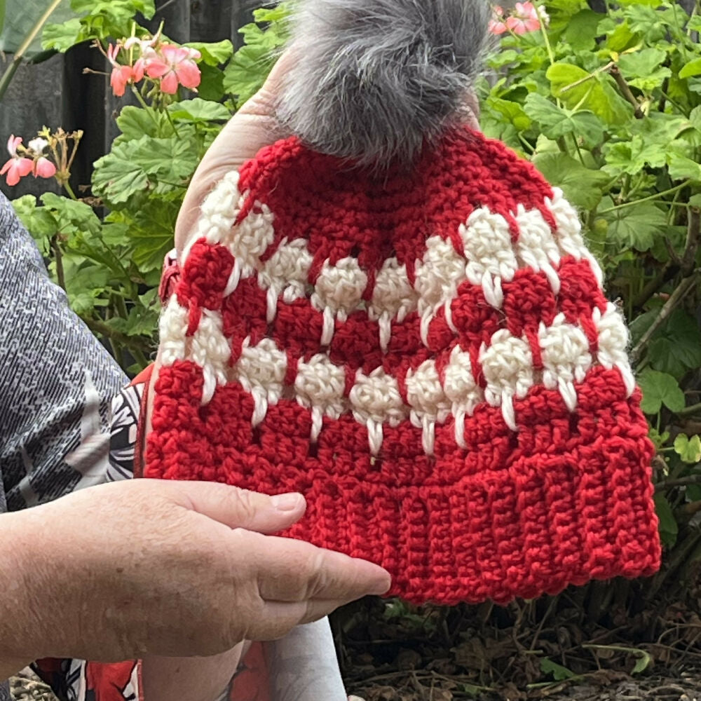Holding red beanie