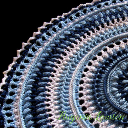 Crochet textured blue and white doily