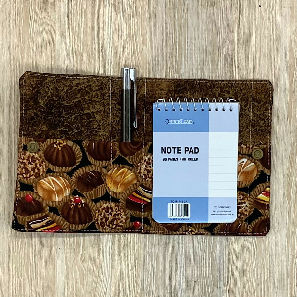 Chocolates refillable fabric pocket notepad cover with snap closure. Incl. book and pen.
