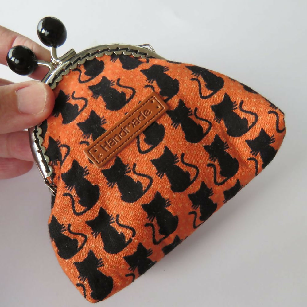 purse flat orange cats close up