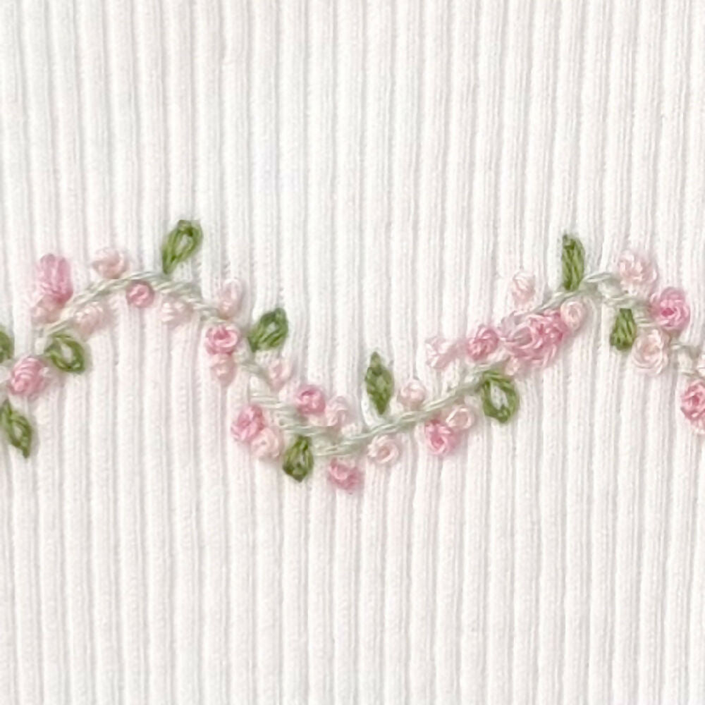 Baby-girl-singlet-vine-pink-rose-close-up