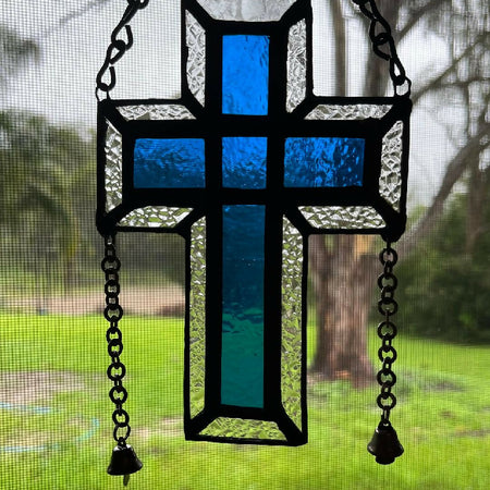 Blue stained glass cross with 2 bells